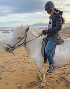 Author on Icelandic Horse on beach during beer tolt