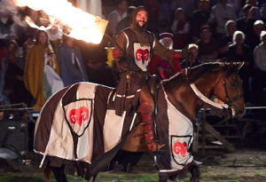 Man jousting on horse with fire
